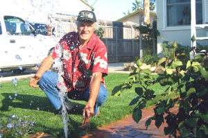 a Petaluma sprinkler repair tech fixing a pop up head