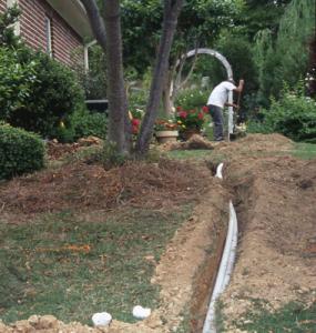 a Sebastapol sprinkler repair tech is laying new pipes